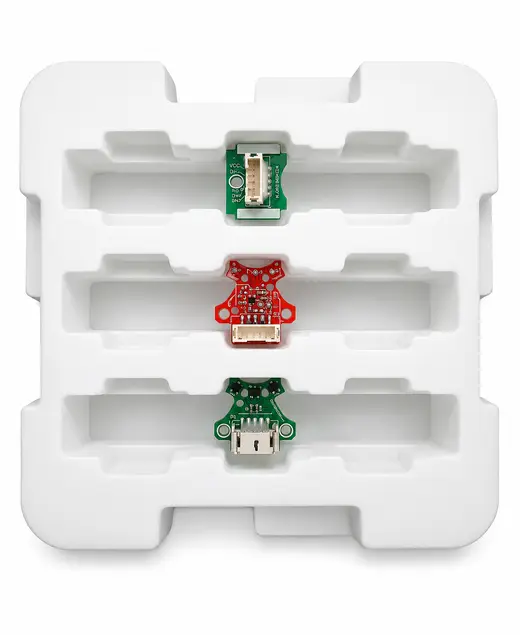 White EPE foam tray with three populated circuit boards seated in routed channels, EMS Technologies