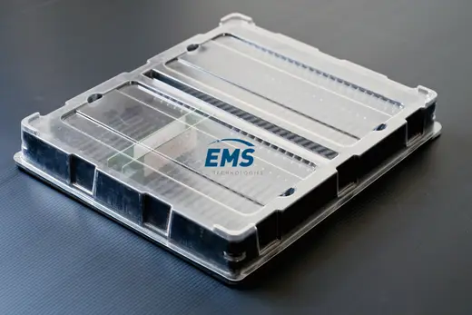 Black HIPS thermoformed ESD tray closed under a clear PET lid, EMS Technologies
