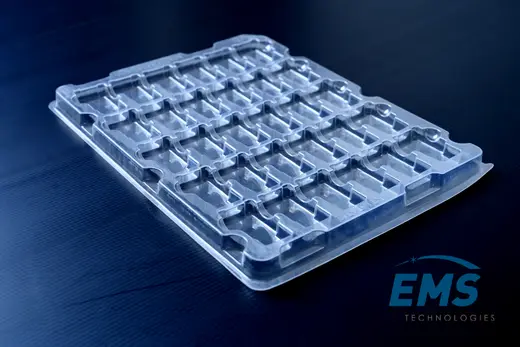 Clear anti-static PET tray with a matrix of moulded component pockets, EMS Technologies