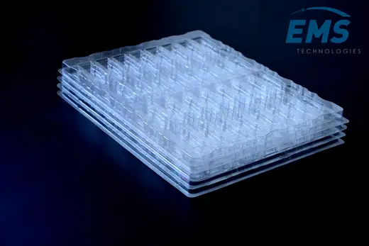 Stack of clear anti-static PET trays nested for storage and transport, EMS Technologies