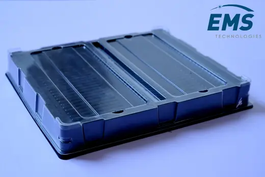 Black HIPS thermoformed ESD tray with a clear PET lid fitted over slotted board channels, EMS Technologies