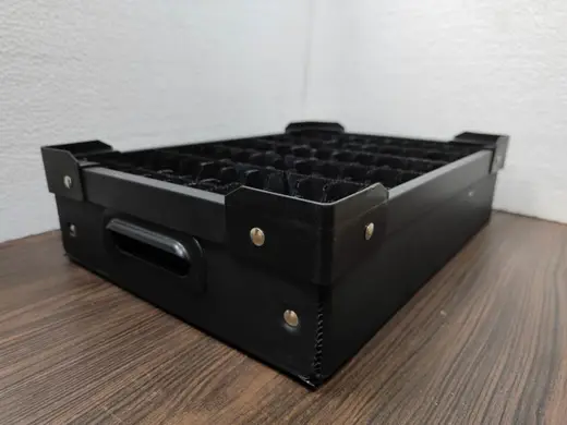 Black PP corrugated ESD bin with riveted corner brackets, hand slot and a partitioned insert, EMS Technologies